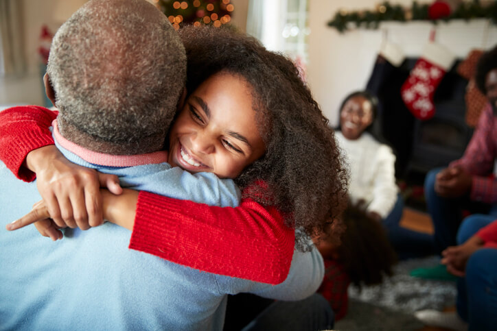 Child hugging grandfather during the holidays