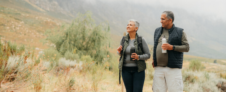 A retired couple walking on a trail