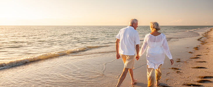 Elderly couple walking on a beach
