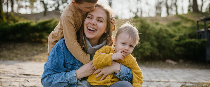 Single mother laughing with her two kids