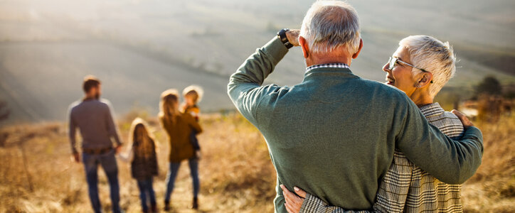 Three-generation family walking down a hill during a hike